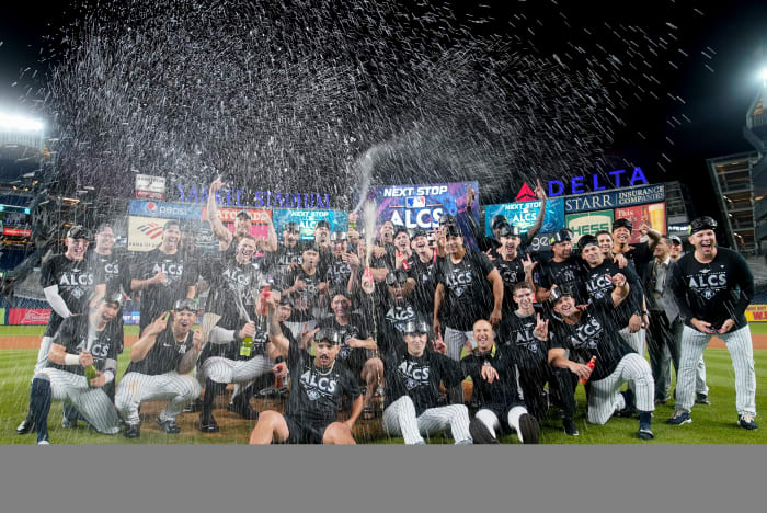 Yankees pose for a photo and pop champagne after beating the Guardians in the ALDS.
